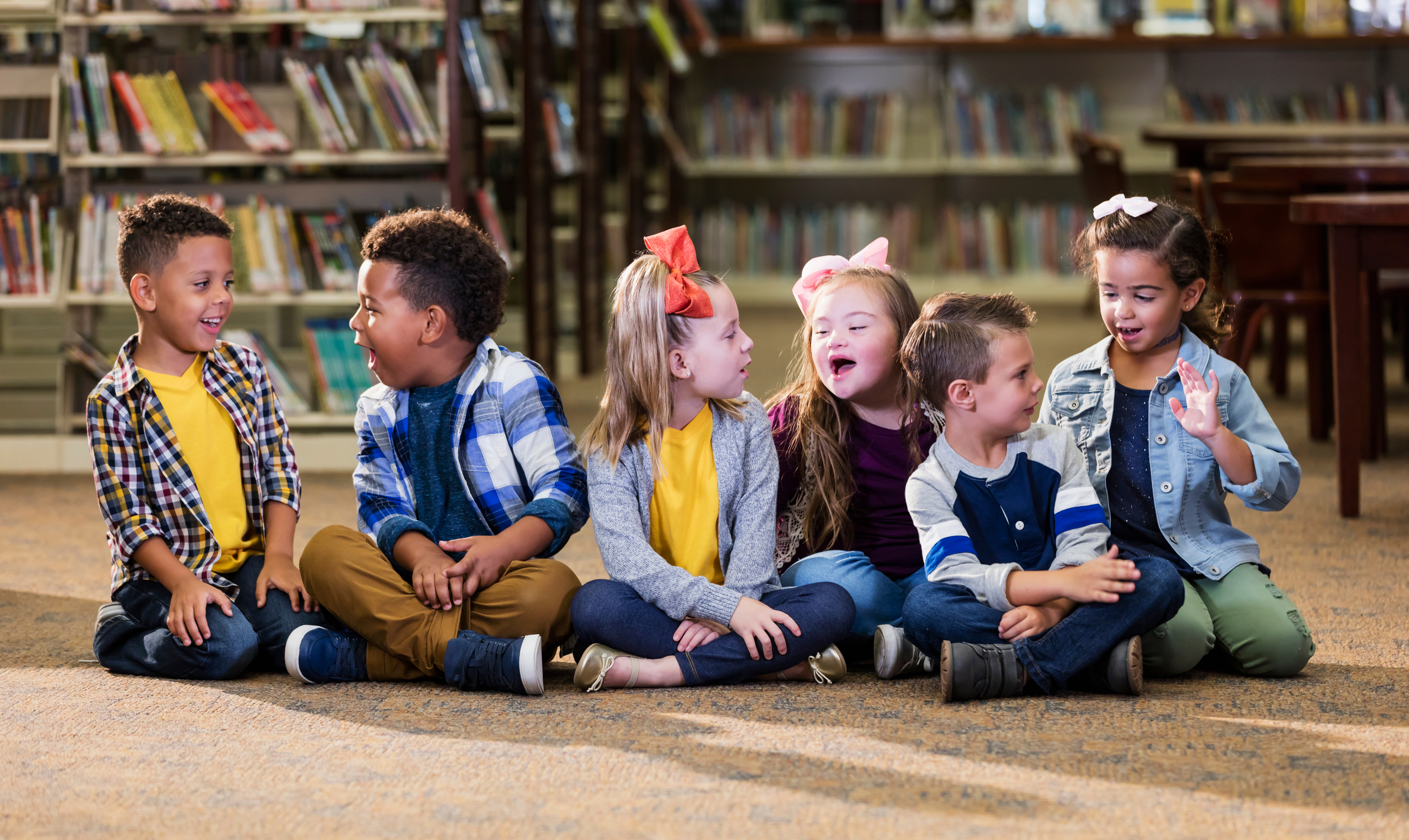 Children in the library, girl with down syndrome